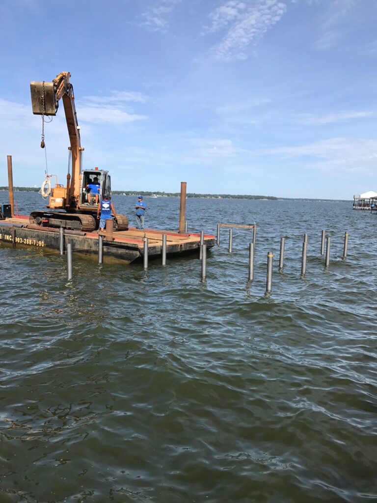 people using a large machine to build a dock
